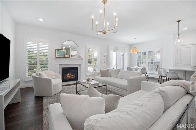 111 Creek Haven Ct, Lake St Louis, MO 63367 - living room with healthy amount of natural light, dark wood-type flooring, a fireplace with flush hearth, a chandelier, and recessed lighting
