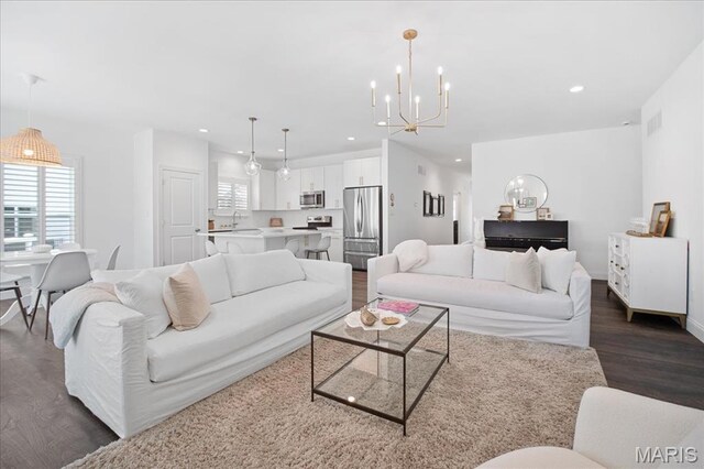 111 Creek Haven Ct, Lake St Louis, MO 63367 - living area with dark wood-style flooring, recessed lighting, a chandelier, and baseboards