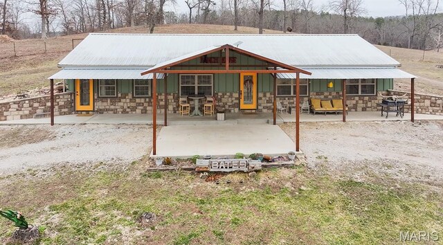 12198 Kitchem Dr, Licking, MO 65542 - rear view of property featuring stone siding, a porch, metal roof, and board and batten siding