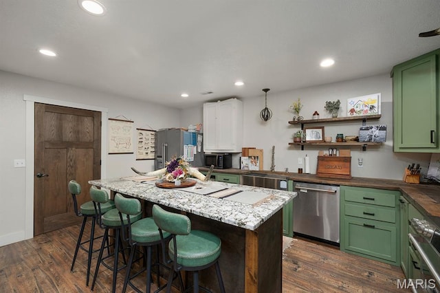 12198 Kitchem Dr, Licking, MO 65542 - kitchen with appliances with stainless steel finishes, green cabinets, a sink, dark wood-type flooring, and recessed lighting