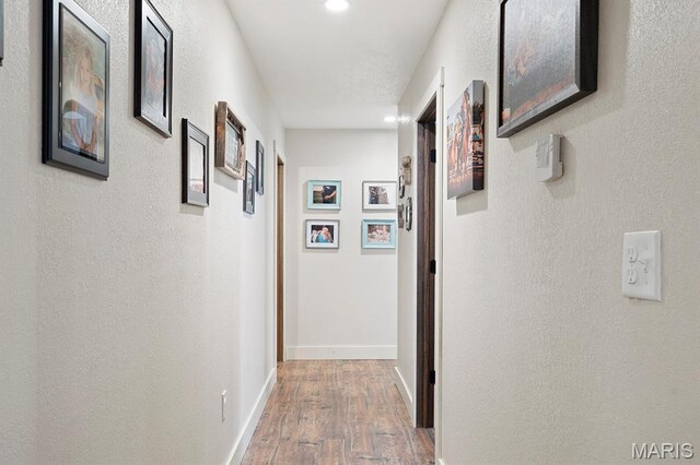 12198 Kitchem Dr, Licking, MO 65542 - hallway featuring wood finished floors, baseboards, and recessed lighting