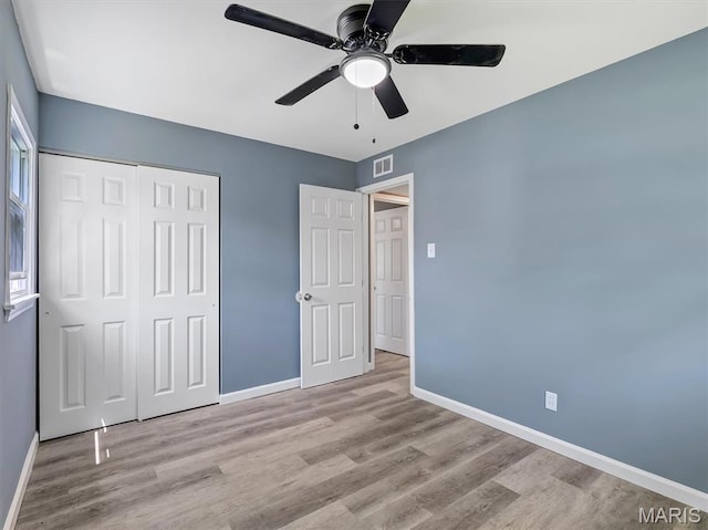 1216 Redman Blvd, Saint Louis, MO 63138 - unfurnished bedroom with a closet, wood finished floors, and a ceiling fan