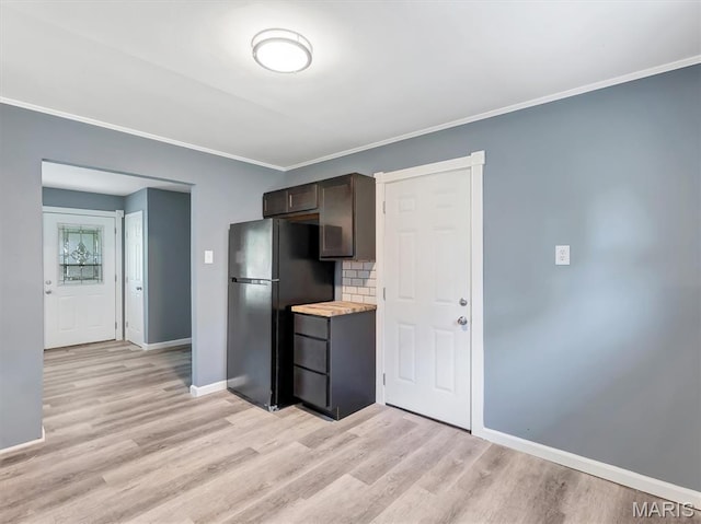 1216 Redman Blvd, Saint Louis, MO 63138 - kitchen featuring freestanding refrigerator, light wood-style floors, dark brown cabinets, light countertops, and ornamental molding
