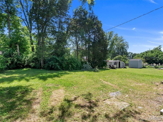 1216 Redman Blvd, Saint Louis, MO 63138 - view of grassy yard with a storage shed