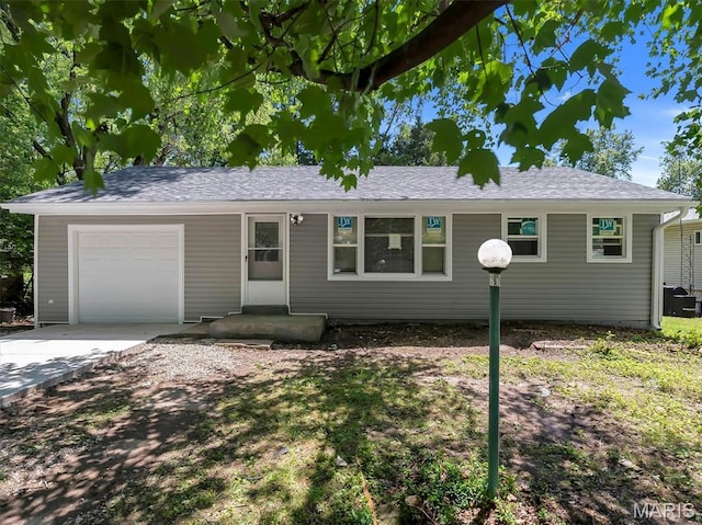 1216 Redman Blvd, Saint Louis, MO 63138 - ranch-style house featuring an attached garage, concrete driveway, and roof with shingles