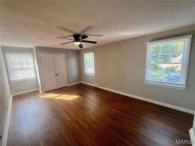 2328 Rockdale Ave, Saint Louis, MO 63121 - unfurnished bedroom featuring baseboards, dark wood-style flooring, and ceiling fan