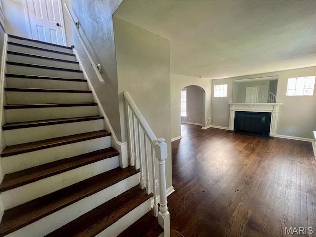 2328 Rockdale Ave, Saint Louis, MO 63121 - stairway with arched walkways, healthy amount of natural light, and wood finished floors