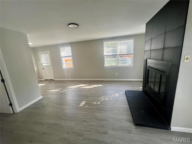 2328 Rockdale Ave, Saint Louis, MO 63121 - unfurnished living room featuring a fireplace, plenty of natural light, and baseboards