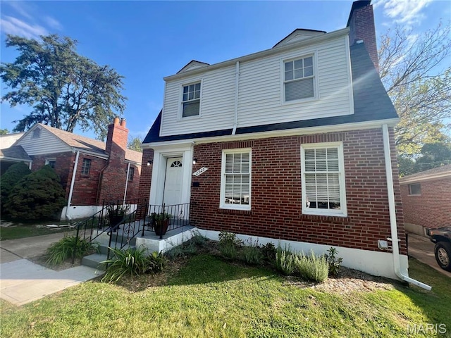 2328 Rockdale Ave, Saint Louis, MO 63121 - view of front of property with brick siding, a chimney, and a front lawn