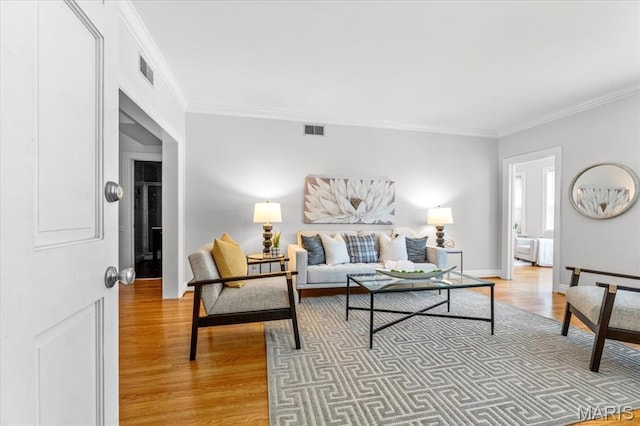 6318 Southwood Ave Unit 1W, Saint Louis, MO 63105 - living area featuring light wood-style flooring, crown molding, and baseboards
