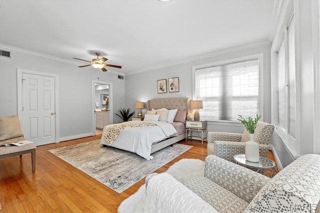 6318 Southwood Ave Unit 1W, Saint Louis, MO 63105 - bedroom featuring crown molding, wood finished floors, baseboards, connected bathroom, and a ceiling fan