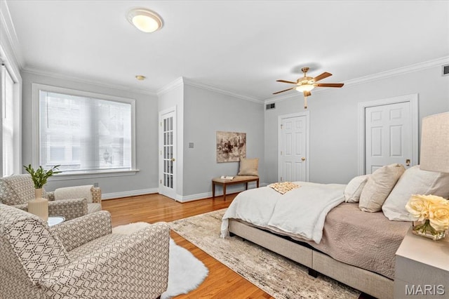 6318 Southwood Ave Unit 1W, Saint Louis, MO 63105 - bedroom with wood finished floors, crown molding, baseboards, and a ceiling fan