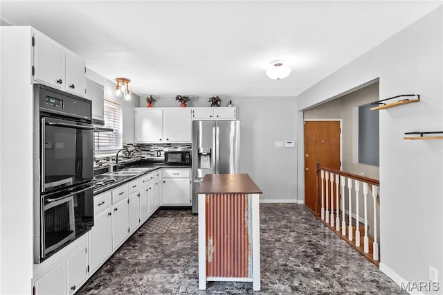 430 Coachway Ln, Hazelwood, MO 63042 - kitchen with stainless steel fridge, dark countertops, white cabinetry, and a kitchen island