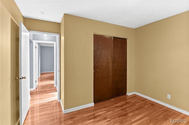 430 Coachway Ln, Hazelwood, MO 63042 - unfurnished bedroom featuring light wood-style floors and a closet