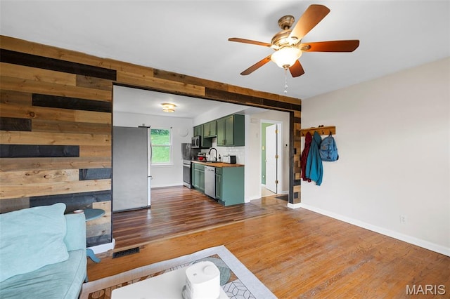 2604 Tamm Ave, Saint Louis, MO 63139 - living area featuring ceiling fan, dark wood-style floors, and wooden walls