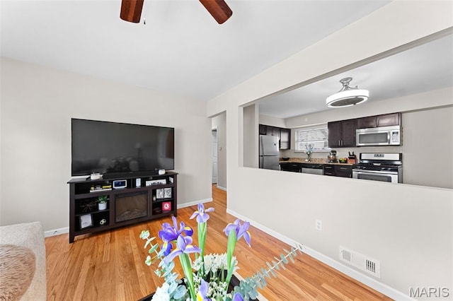 4620 Kramer Dr, Saint Louis, MO 63123 - living area with a ceiling fan and light wood-type flooring