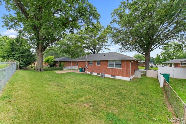 4620 Kramer Dr, Saint Louis, MO 63123 - back of property with brick siding, a fenced backyard, and a patio