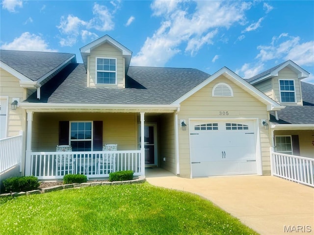305 Hawk Nest Ct, Union, MO 63084 - cape cod house featuring a porch, an attached garage, driveway, roof with shingles, and a front yard