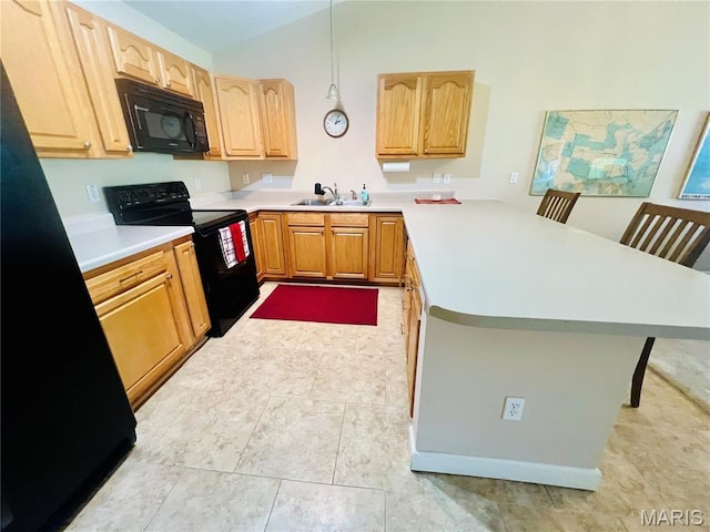 305 Hawk Nest Ct, Union, MO 63084 - kitchen featuring black appliances, a peninsula, light countertops, vaulted ceiling, and a kitchen breakfast bar