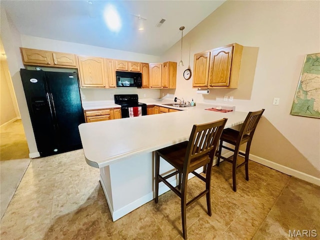 305 Hawk Nest Ct, Union, MO 63084 - kitchen featuring black appliances, a peninsula, light countertops, lofted ceiling, and a kitchen breakfast bar