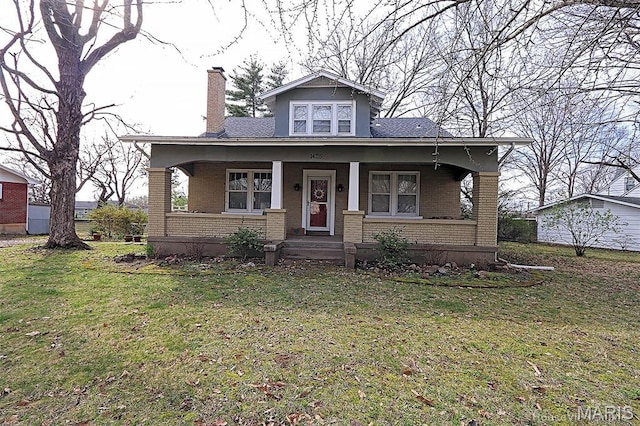 1425 Perryville Cpe, Girardeau, MO 63701 - view of front of home featuring brick siding, a chimney, a porch, and a front lawn