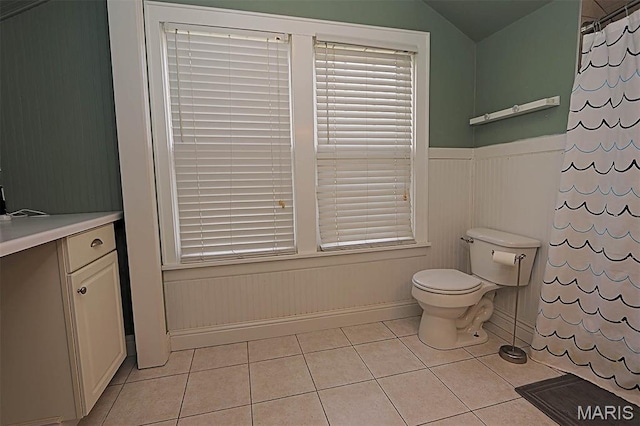 1425 Perryville Cpe, Girardeau, MO 63701 - bathroom featuring toilet, tile patterned floors, vanity, lofted ceiling, and wainscoting
