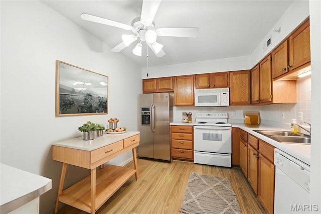 3425 Country Stone Manor Dr Unit G, Valley Park, MO 63088 - kitchen featuring white appliances, brown cabinets, light wood finished floors, light countertops, and ceiling fan