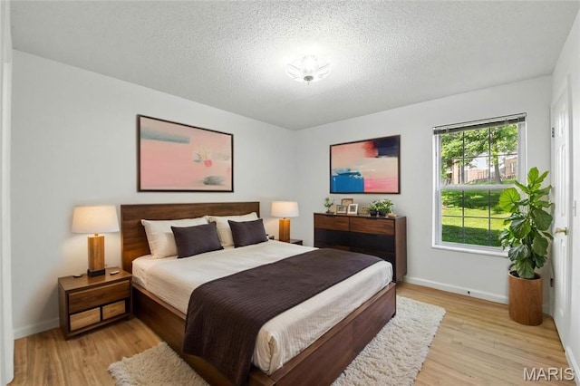 3425 Country Stone Manor Dr Unit G, Valley Park, MO 63088 - bedroom featuring light wood-style flooring and a textured ceiling