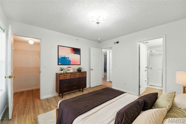 3425 Country Stone Manor Dr Unit G, Valley Park, MO 63088 - bedroom featuring a spacious closet, light wood finished floors, a textured ceiling, and a closet