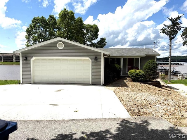 63 Rock Dove Ln, Camdenton, MO 65020 - view of front of home featuring driveway, an attached garage, and a water view
