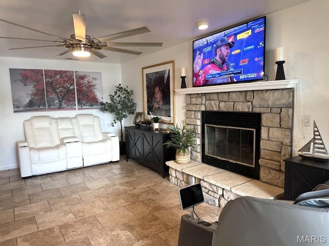 63 Rock Dove Ln, Camdenton, MO 65020 - living room featuring ceiling fan, stone finish floors, a stone fireplace, and baseboards