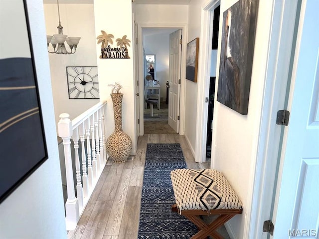 63 Rock Dove Ln, Camdenton, MO 65020 - corridor with wood finished floors, a chandelier, and an upstairs landing