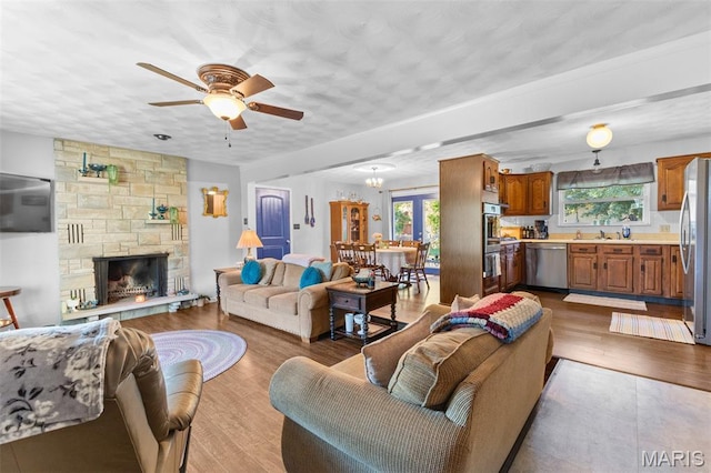 611 Park St, Farmington, MO 63640 - living area with ceiling fan, a fireplace, and wood finished floors