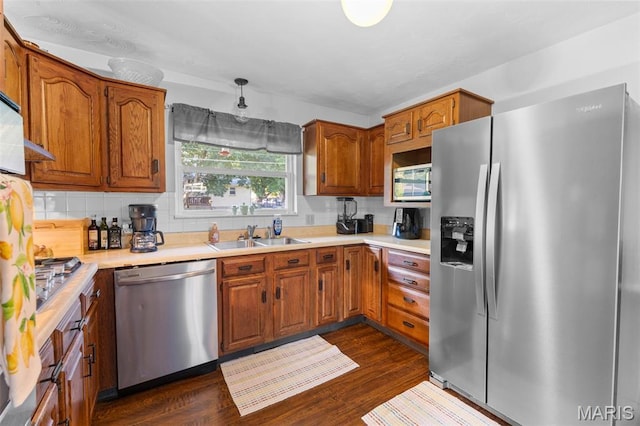 611 Park St, Farmington, MO 63640 - kitchen featuring stainless steel appliances, tasteful backsplash, brown cabinets, and dark wood-type flooring