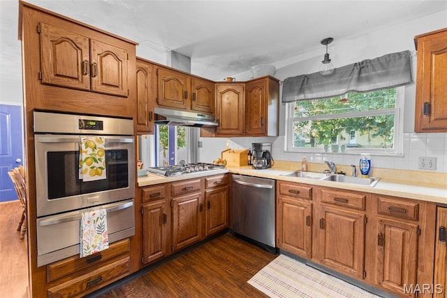 611 Park St, Farmington, MO 63640 - kitchen with appliances with stainless steel finishes, a warming drawer, under cabinet range hood, and brown cabinets