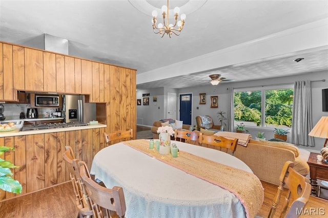 611 Park St, Farmington, MO 63640 - dining area with wood finished floors, ceiling fan, and a chandelier