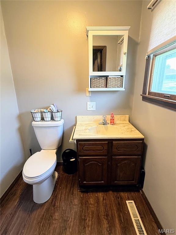 408 Clay, Edina, MO 63537 - half bathroom featuring wood finished floors and vanity