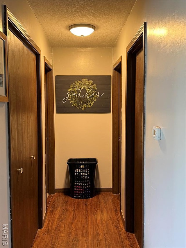 408 Clay, Edina, MO 63537 - hallway featuring wood finished floors and a textured ceiling