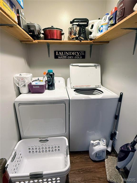 408 Clay, Edina, MO 63537 - washroom with washing machine and dryer and dark wood-style floors