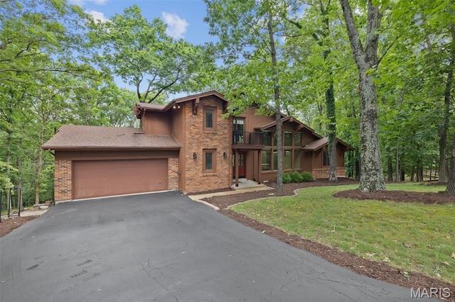 1509 Redbriar Dr, High Ridge, MO 63049 - view of front of home with a balcony, driveway, brick siding, a garage, and a front yard