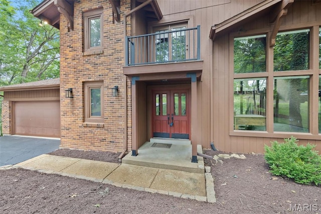 1509 Redbriar Dr, High Ridge, MO 63049 - entrance to property featuring a balcony, a garage, brick siding, and asphalt driveway