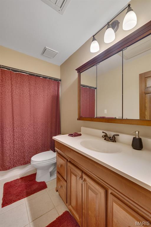 1509 Redbriar Dr, High Ridge, MO 63049 - full bathroom with vanity and tile patterned flooring