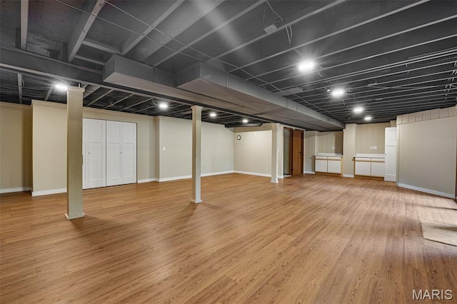 1509 Redbriar Dr, High Ridge, MO 63049 - finished basement featuring light wood-type flooring and baseboards