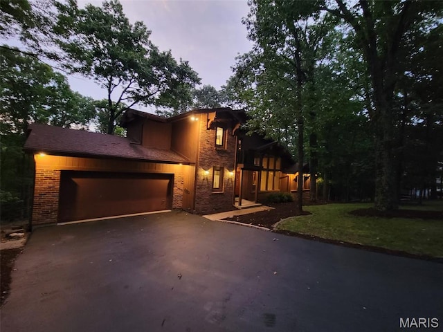 1509 Redbriar Dr, High Ridge, MO 63049 - view of front of home with driveway, brick siding, an attached garage, and a front lawn