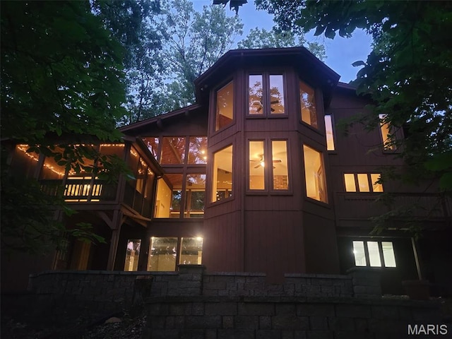 1509 Redbriar Dr, High Ridge, MO 63049 - rear view of property with a sunroom and stone siding