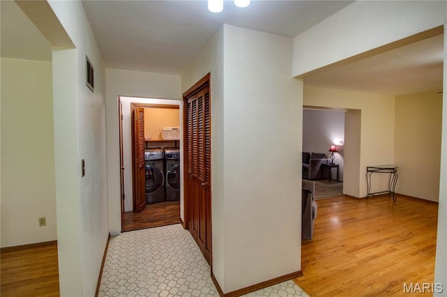 10000 Wondell Woods Dr, Belleville, IL 62223 - hallway with independent washer and dryer and light wood-type flooring