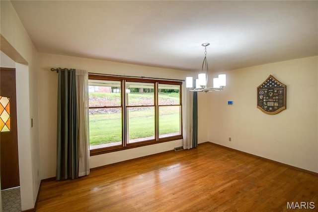 10000 Wondell Woods Dr, Belleville, IL 62223 - unfurnished dining area featuring a chandelier and light wood-style flooring