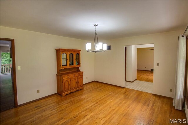 10000 Wondell Woods Dr, Belleville, IL 62223 - unfurnished dining area featuring a chandelier and light wood finished floors