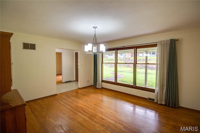 10000 Wondell Woods Dr, Belleville, IL 62223 - empty room with a chandelier and light wood-style flooring