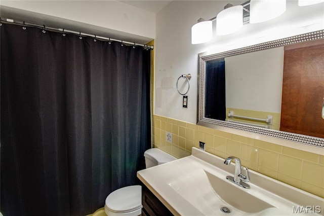 10000 Wondell Woods Dr, Belleville, IL 62223 - full bathroom featuring vanity, tile walls, curtained shower, and a wainscoted wall